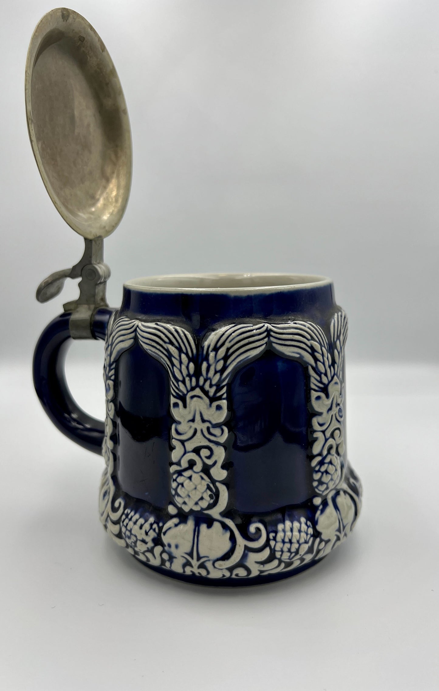 Antique beer mug in blue with metal cap