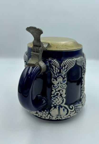 Antique beer mug in blue with metal cap